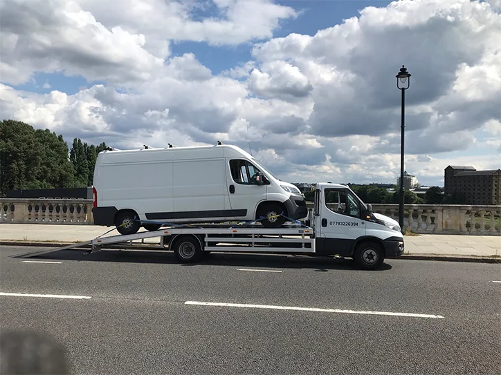 Reliable van towing on a road.
