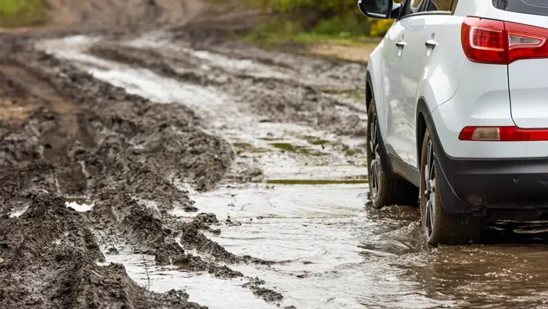 Car driving through mud.