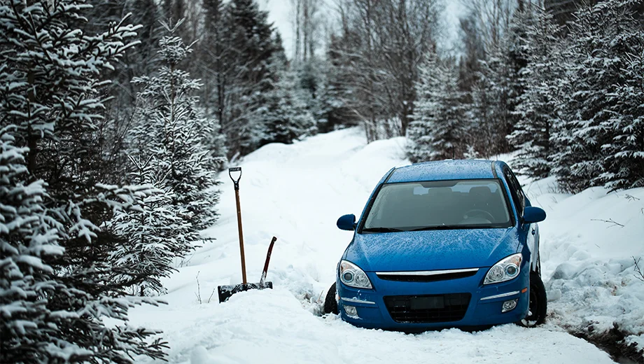 Blue car stuck in snow.