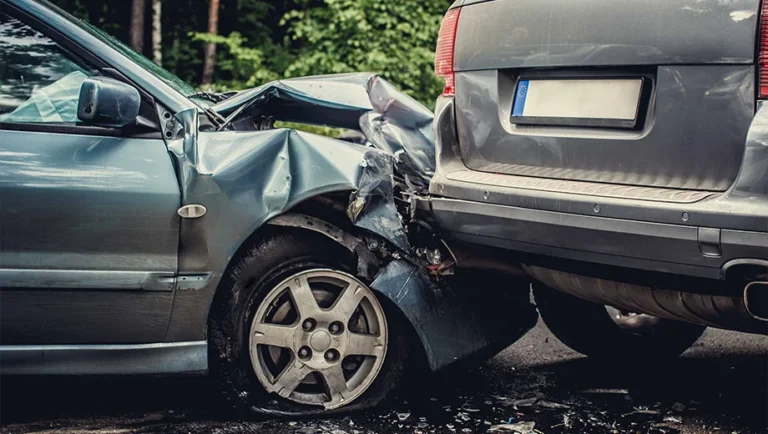 A car accident involving two vehicles on the road, showing the aftermath of the collision.