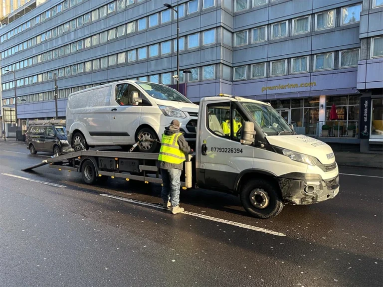 Bodek Recovery team performing van recovery in Greenford: Loading a white Ford Transit onto a recovery truck.